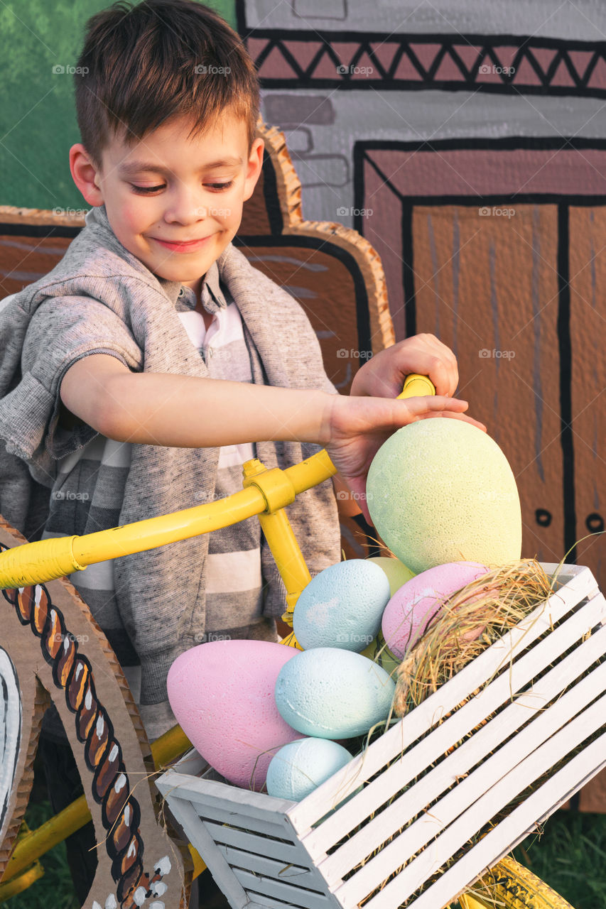 Cute boy playing with easter eggs