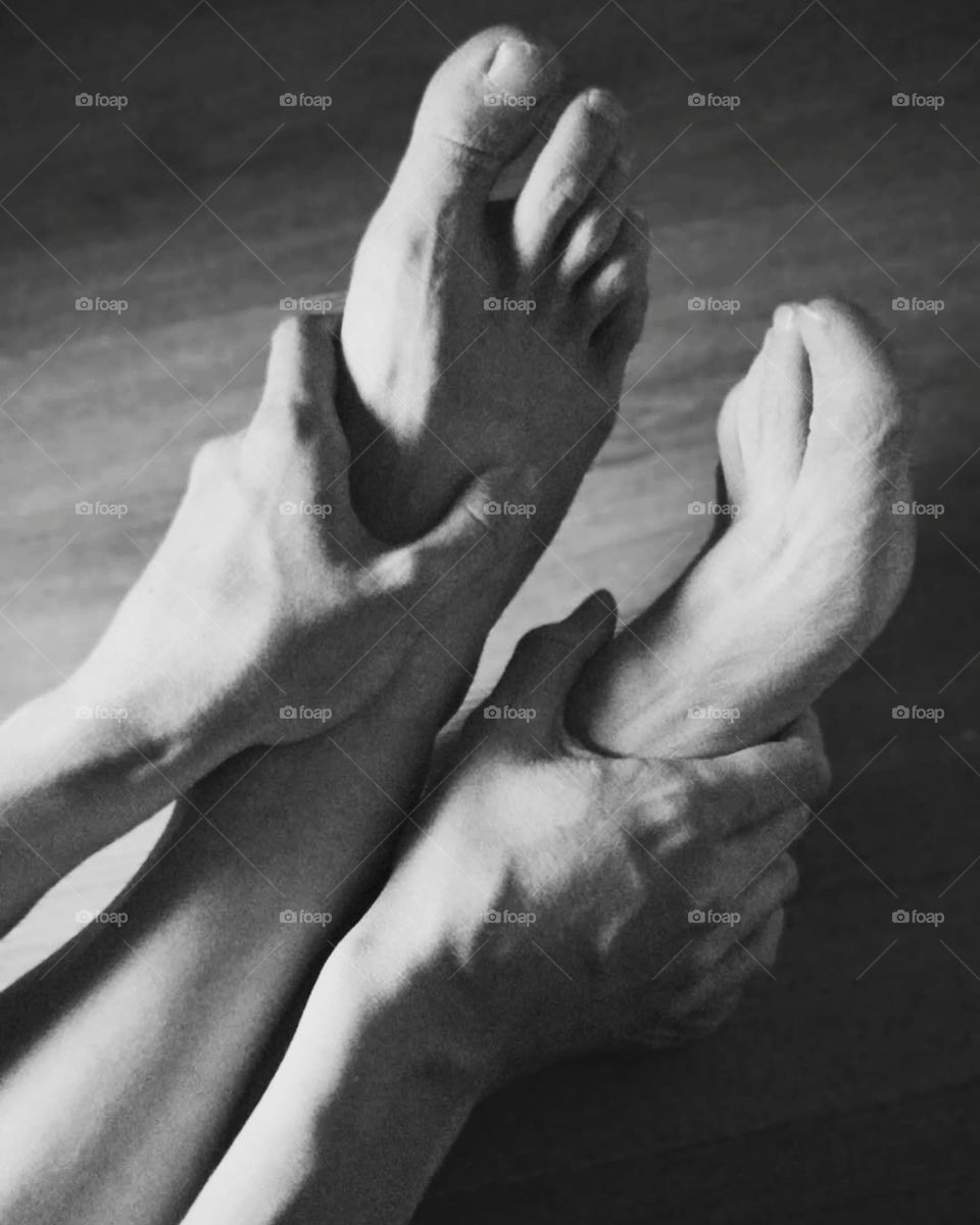 Black and white woman's feet and hands