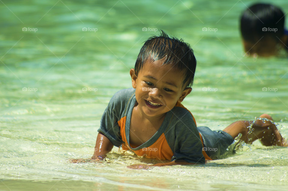 Asian boy enjoying at beach