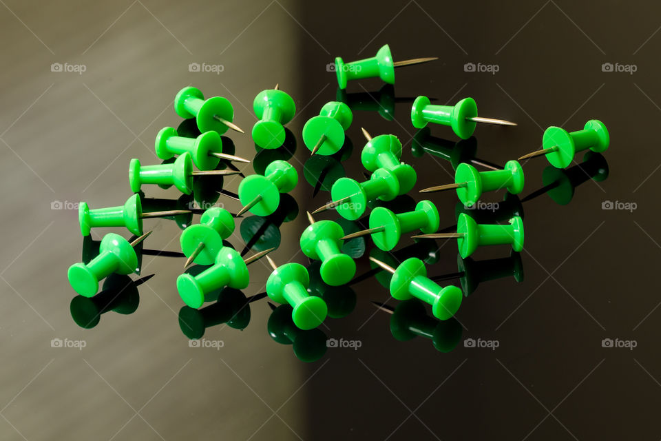 Randomly distributed green thumbtacks