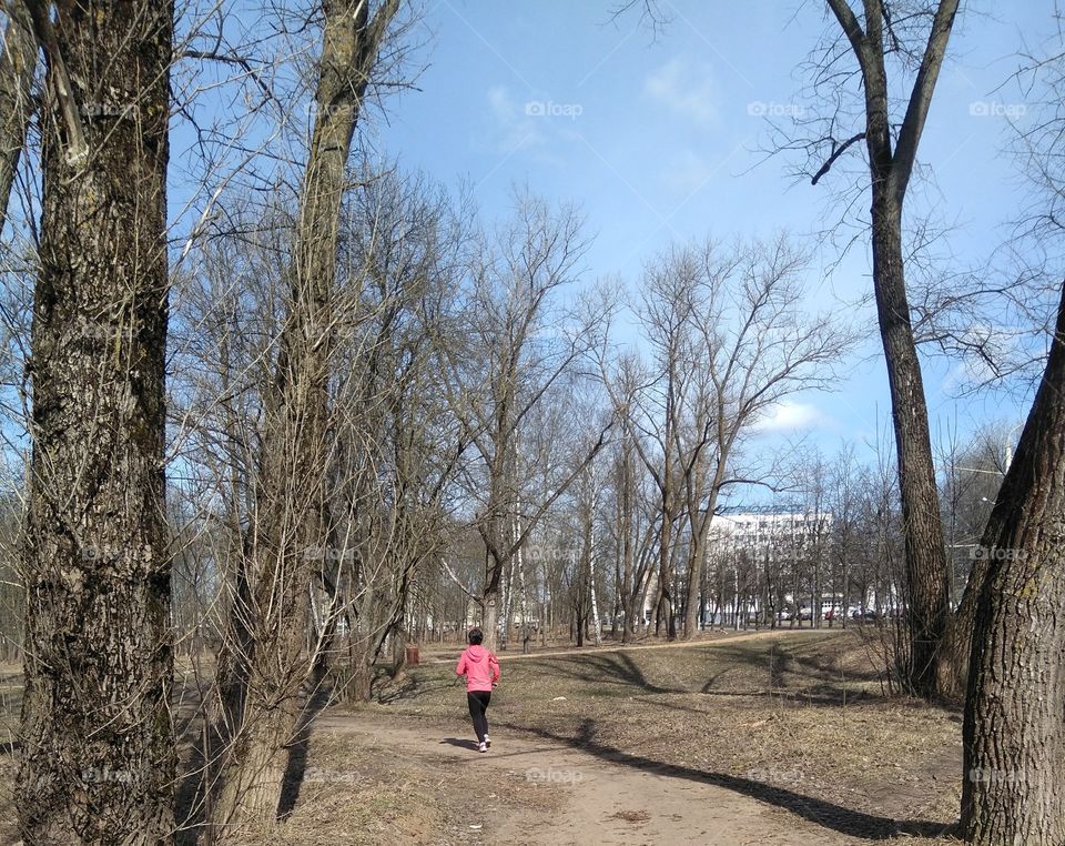 girl running in the solar park spring time