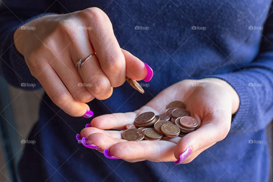 Mid section of women holding coins