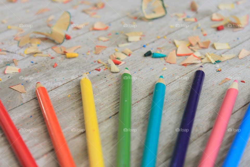 Multi colored pencils on wooden table