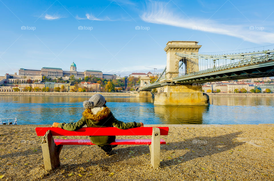 Enjoying morning sunlight and view of Budapest famous landmarks at riverbank