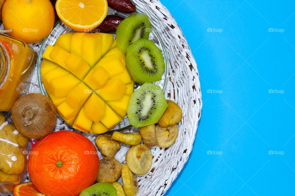 Winter fruit detox: lemon, tangerine, kiwi, mango, dried figs and dates