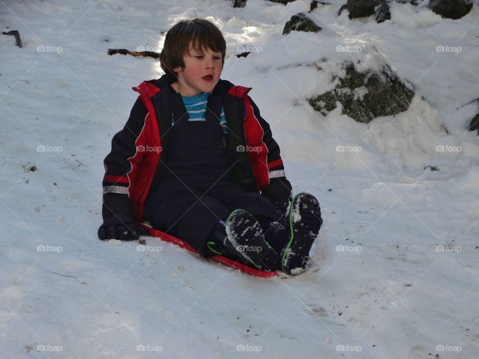 Boy Riding Snow Sled