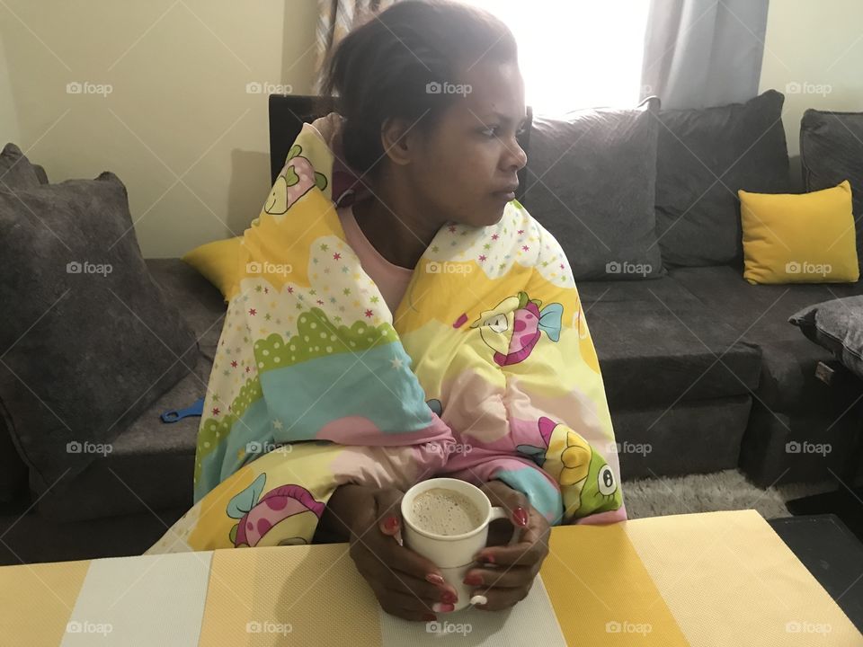 A beautiful young woman holding a cup of coffee 