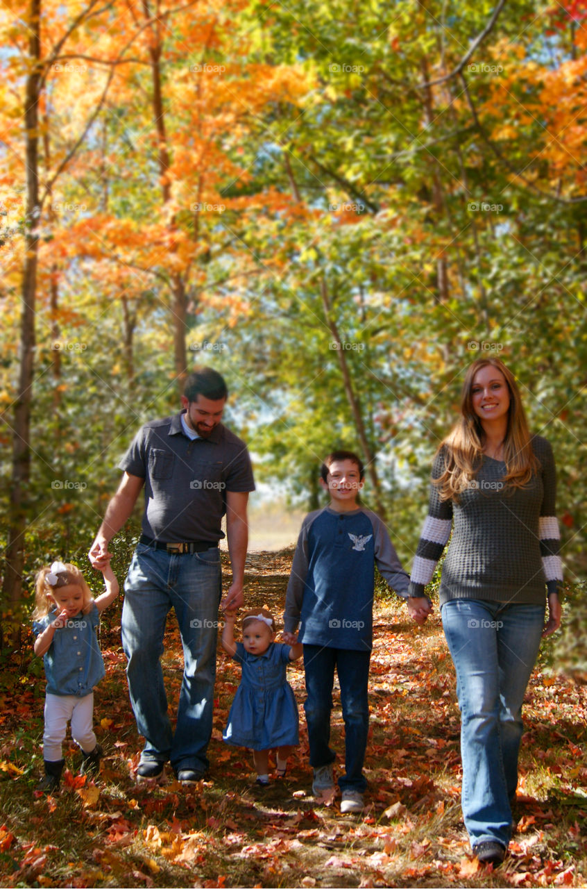 Happy family walking in the forest