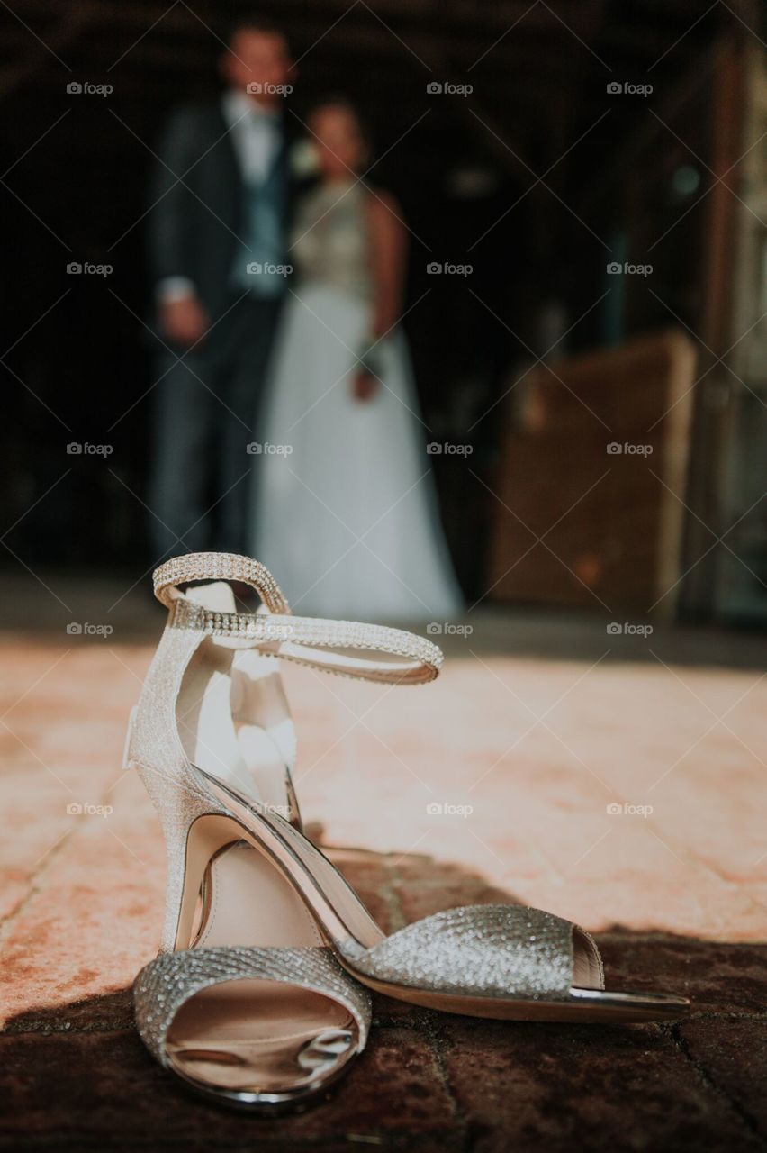 Diamond shoes with couple blurred out in background 