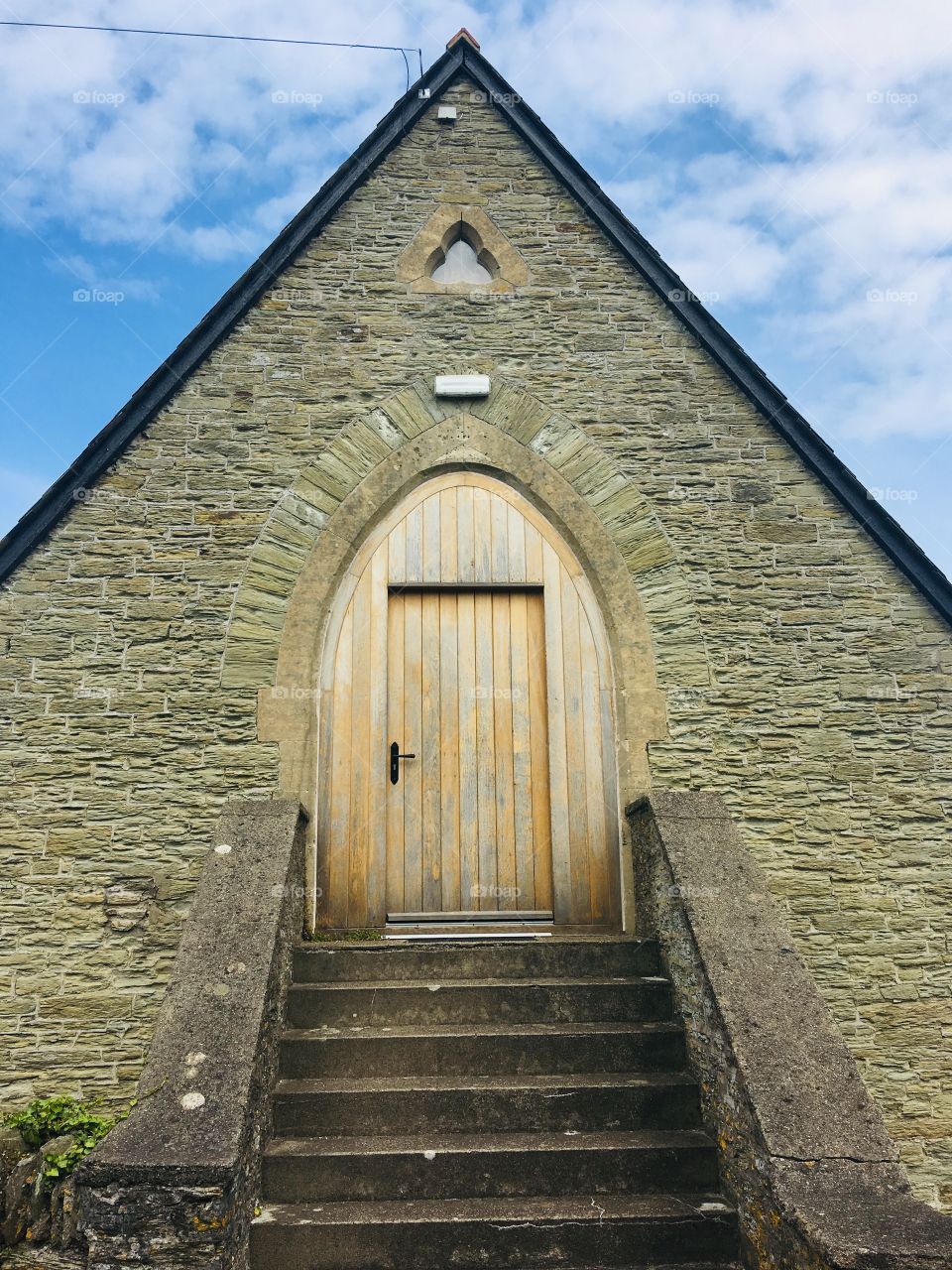 Through the door of symmetry. This beautifully aligned structure in Ilfracombe, North Devon under a blue and cloudy sky.