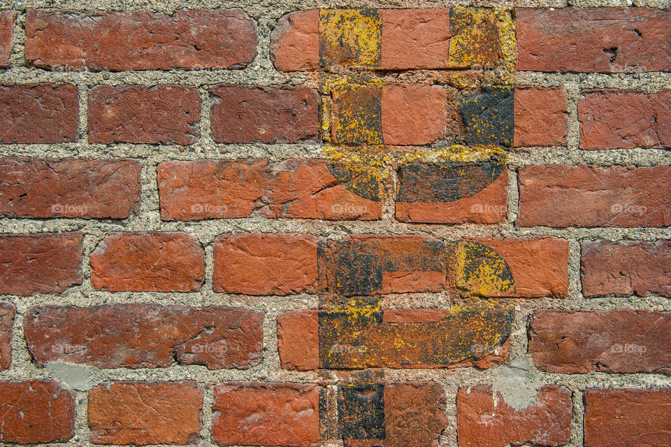 brick wall with the letters u and p 