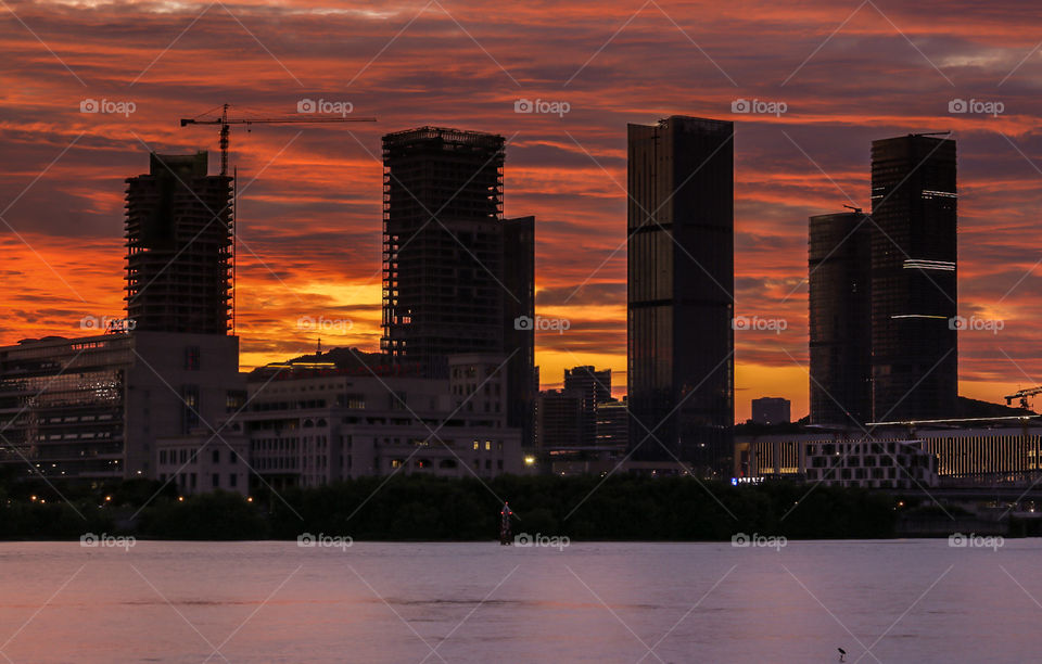 Commercial structures from a nearby city during Twilights.