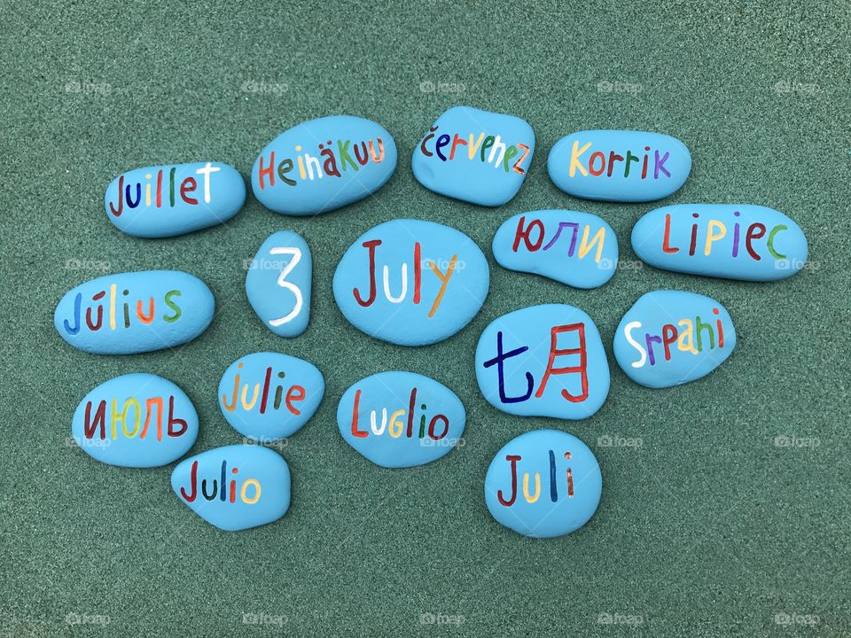 3 July, calendar date in many languages over colored stones