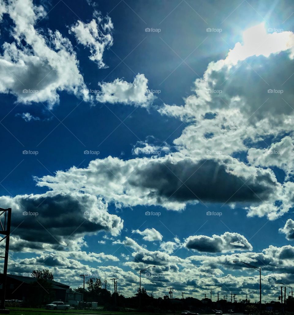 Beautiful day with the Sun peaking behind the fluffy clouds. 