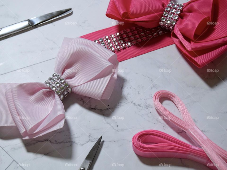 Beautiful pale and hot pink bows, secured with diamanté centres accompanied by silver scissors & pink ribbon.