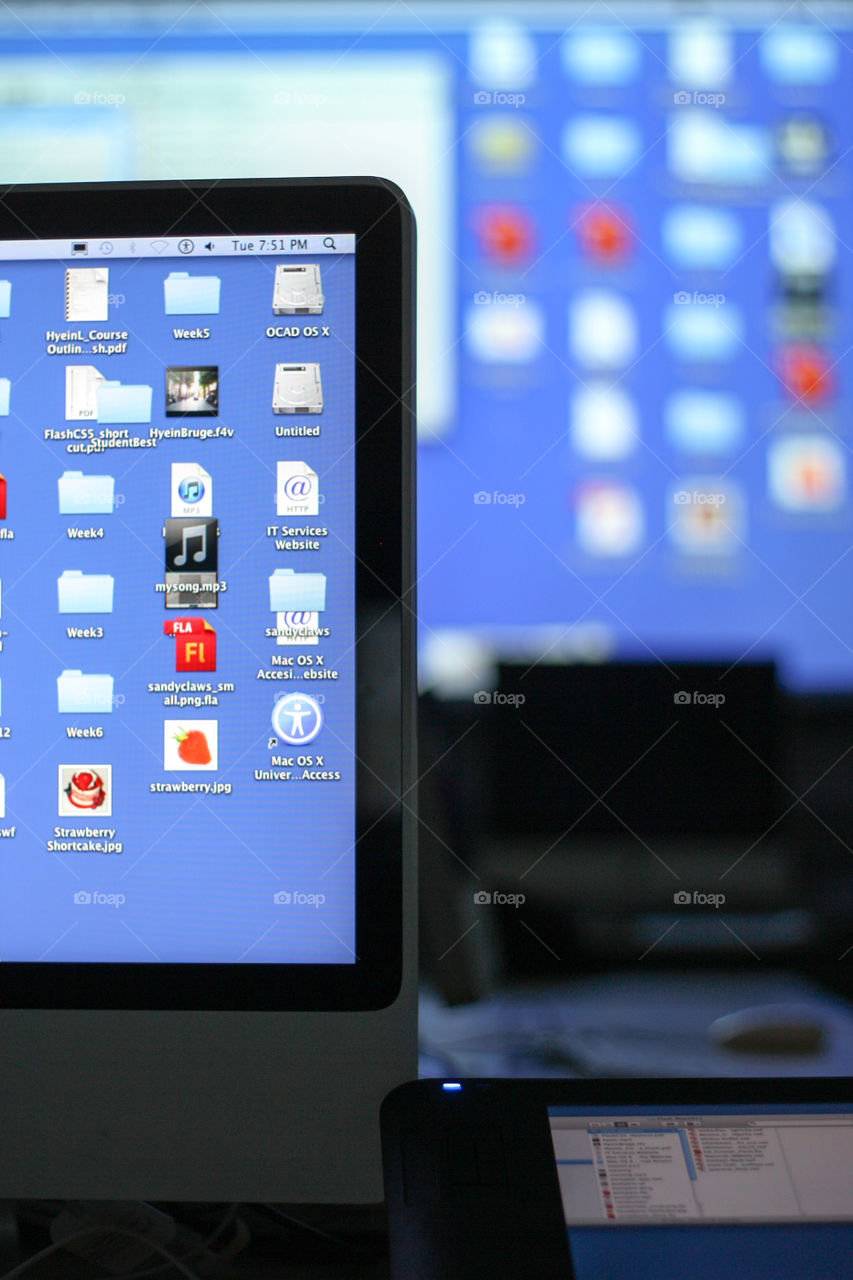 Computer screens glow in a darkened computer lab