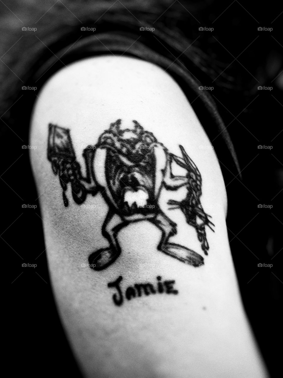 A black and white tattoo of the Tazmanian devil