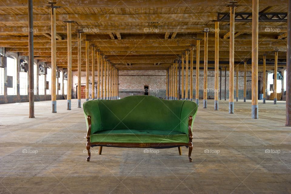 Vintage antique sofa in an empty warehouse 