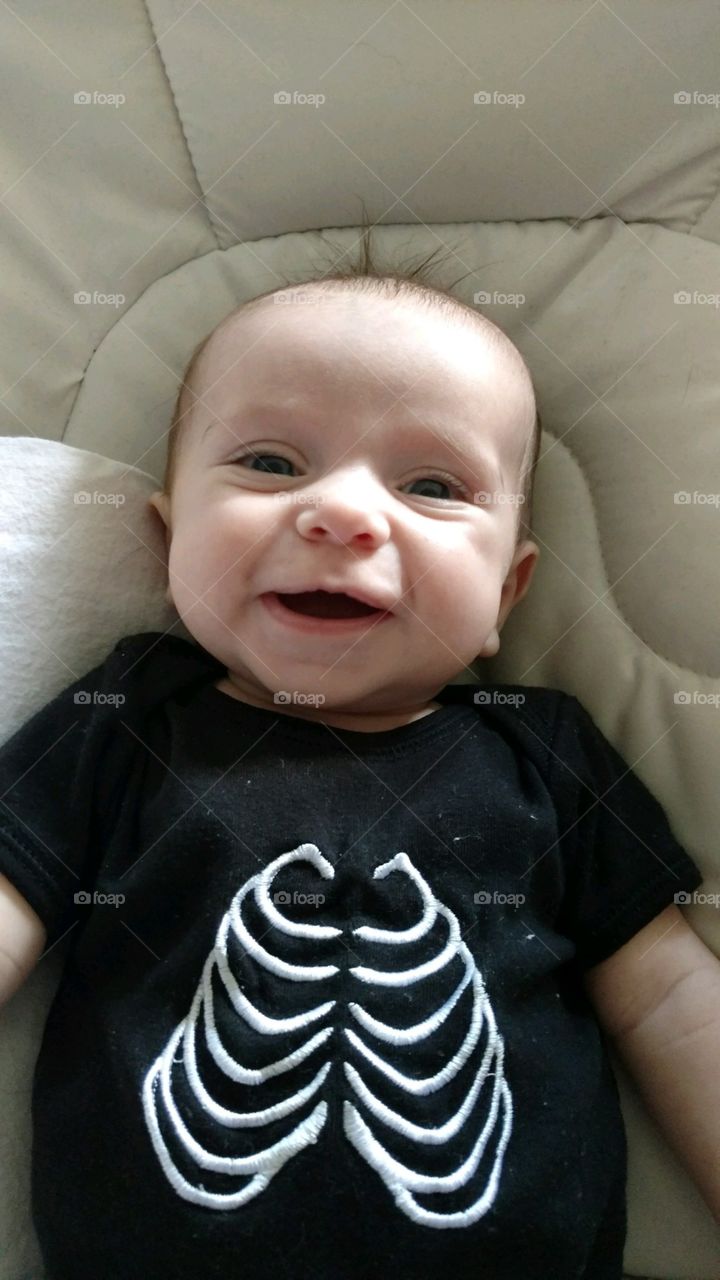 Smiling Baby wearing skeleton shirt