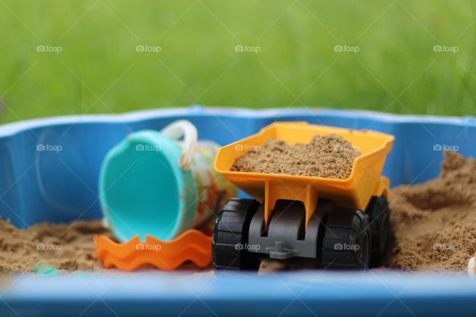 Colorful toys in a sandbox