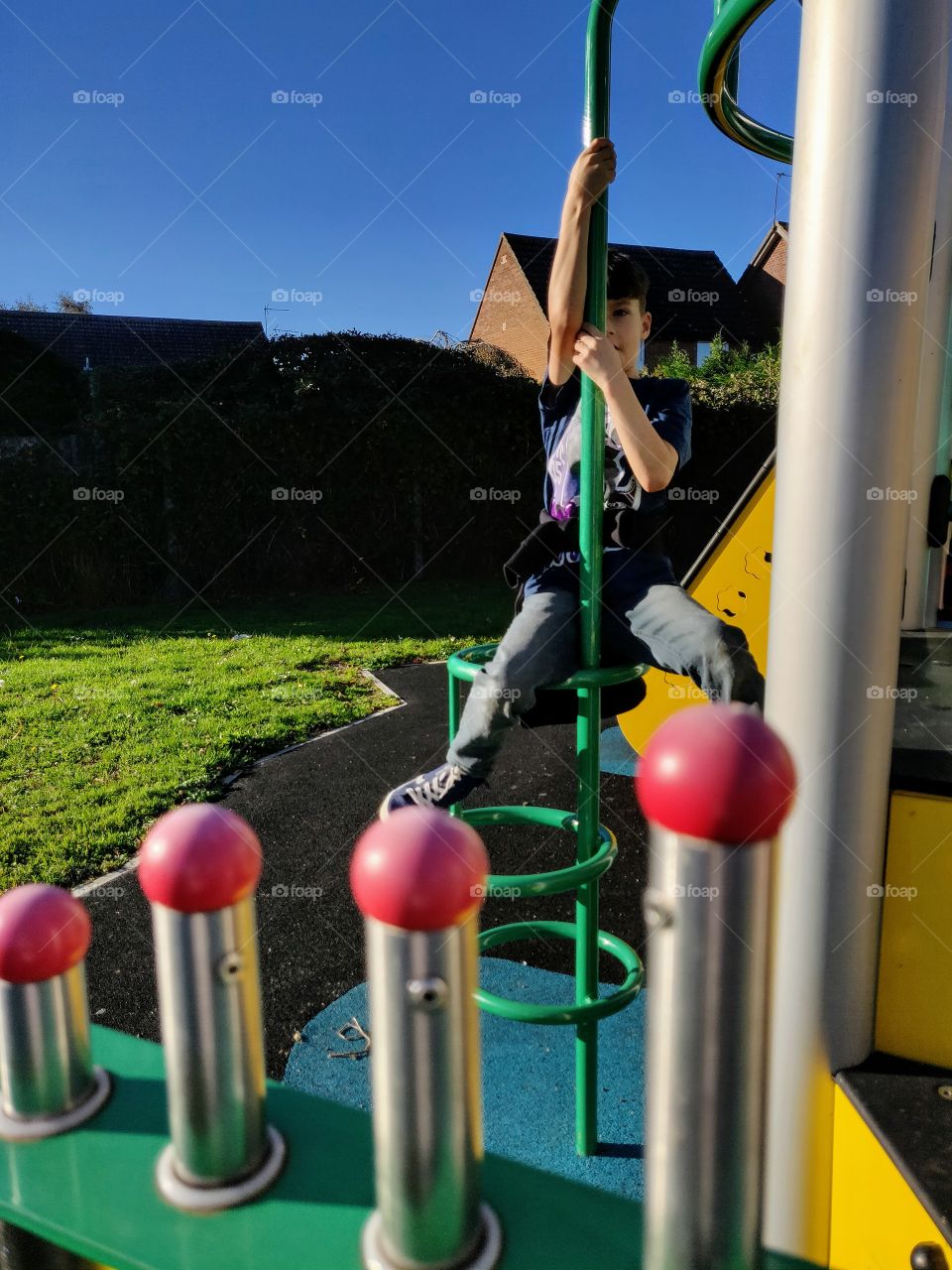 Boy playing on playground equipment