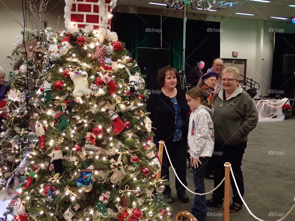 People enjoying some of the beautifully decorated Christmas trees at the annual Central Oregon Festival of Trees fundraising event during the holiday season. 