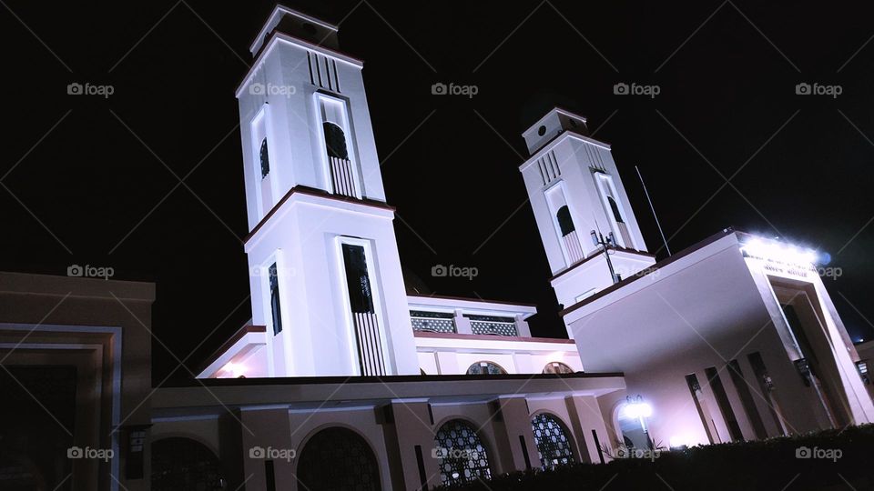 Two minarets of the mosque at night