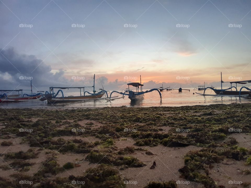 Boats and the pinky sky on the beach