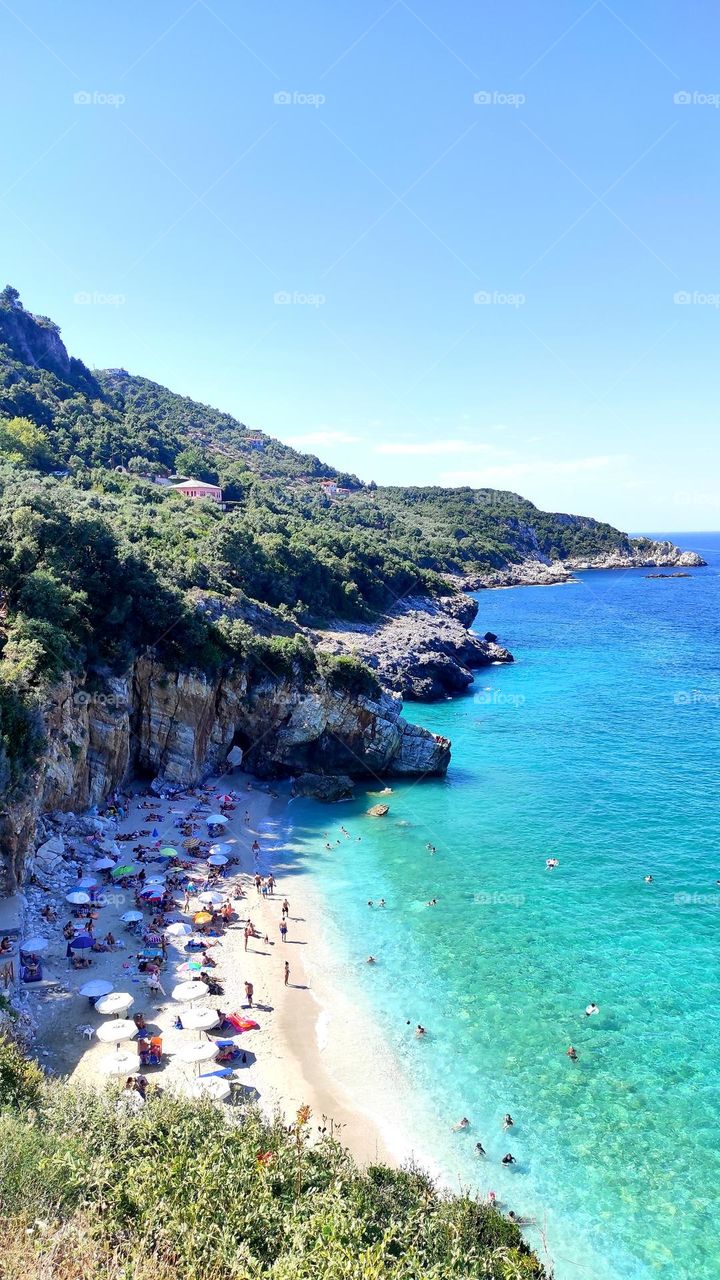 The magnificent beach of Milopotamos, in mount Pelion, Greece. A pebbled beach, with exotic, crystal water and unique beauty, under the shade of the rocks and the pine trees. Heaven is a place on earth!