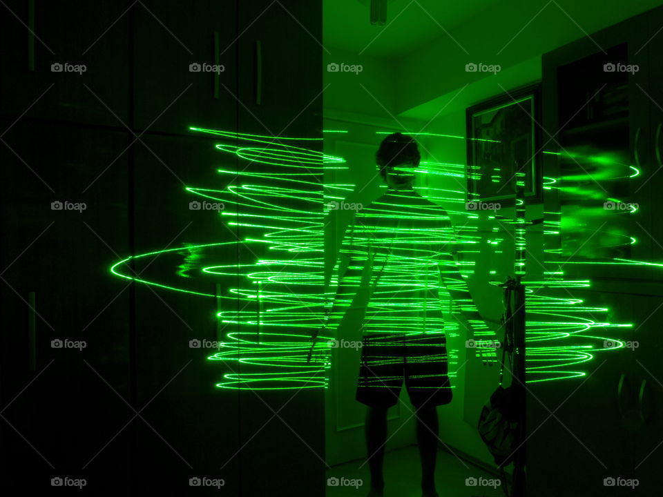 Close-up of teenage man and light trail