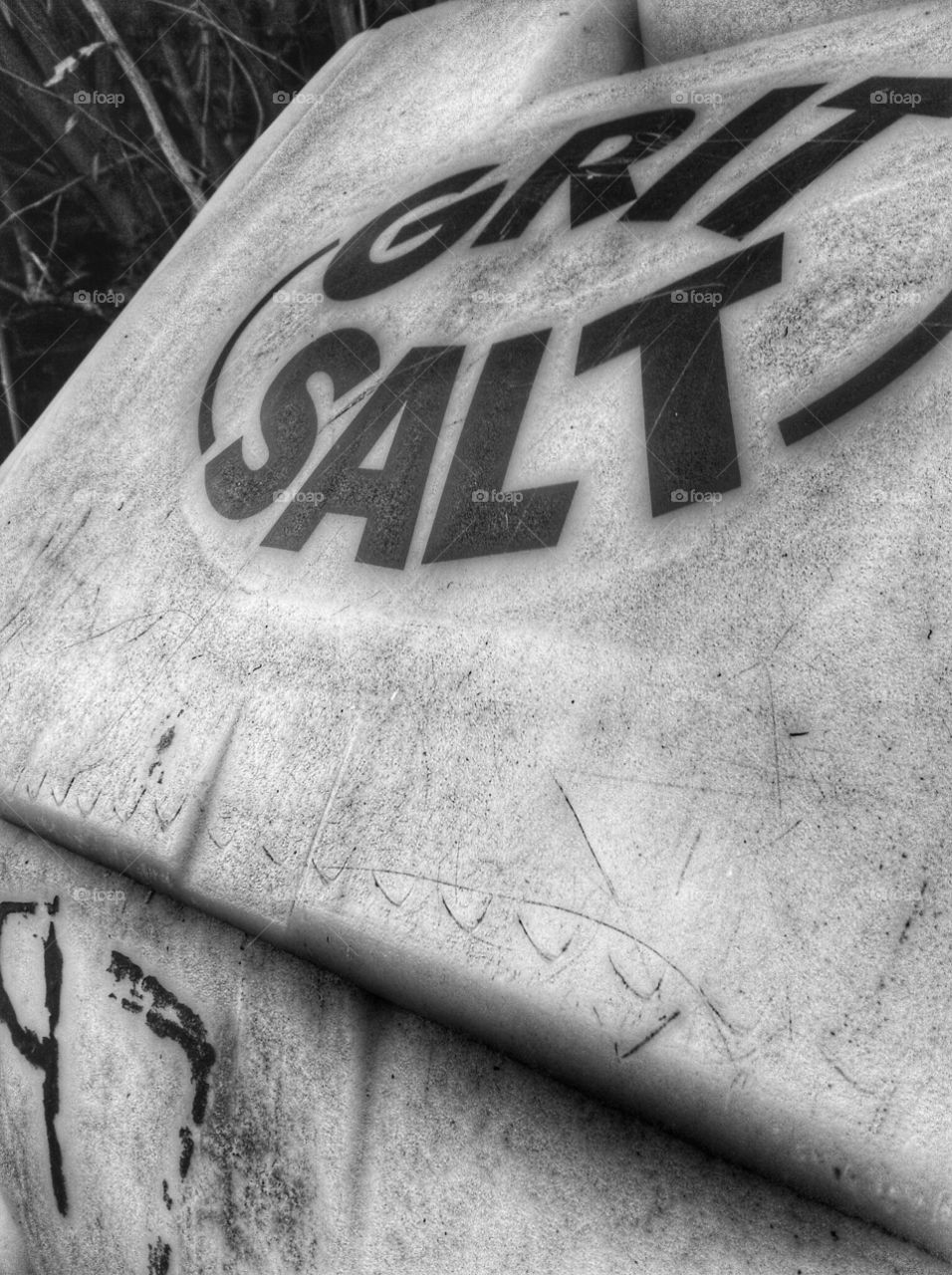 Close up of a salt grit bin in black and white.