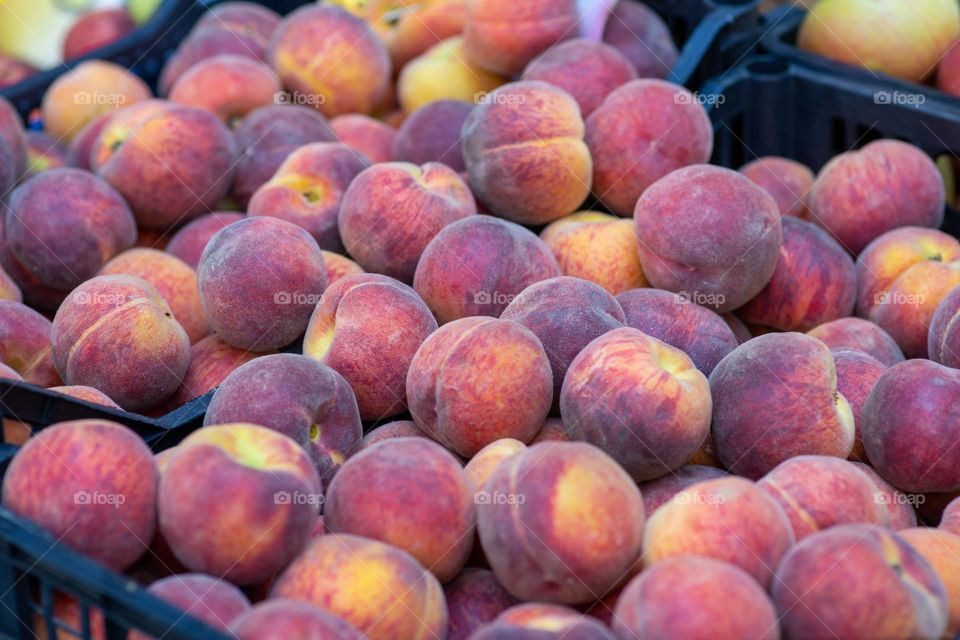 fresh peaches on market stall