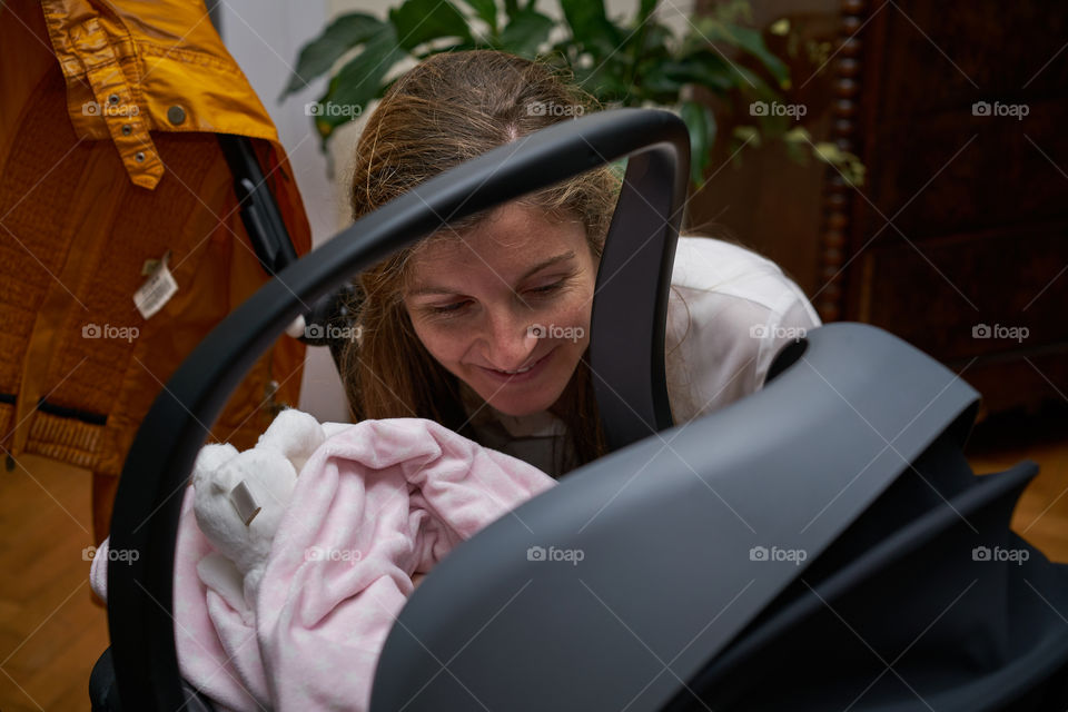 Mother looking at her baby in stroller