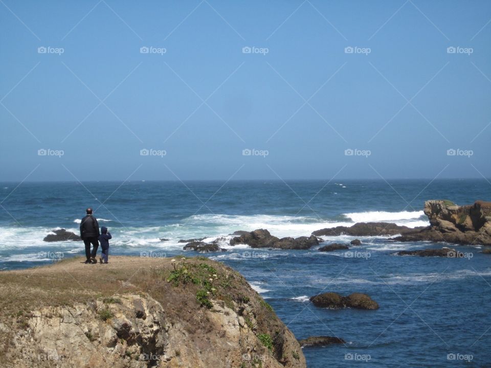 Man and kid admiring the coastal view