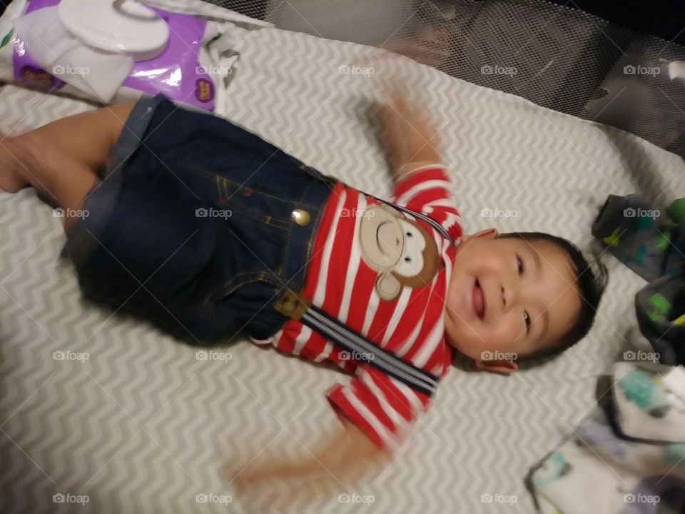 Happy baby boy in striped monkey shirt