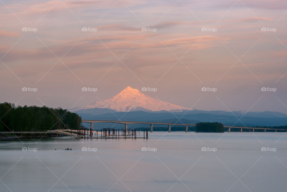 Subtle sunset colors over mountain and river 