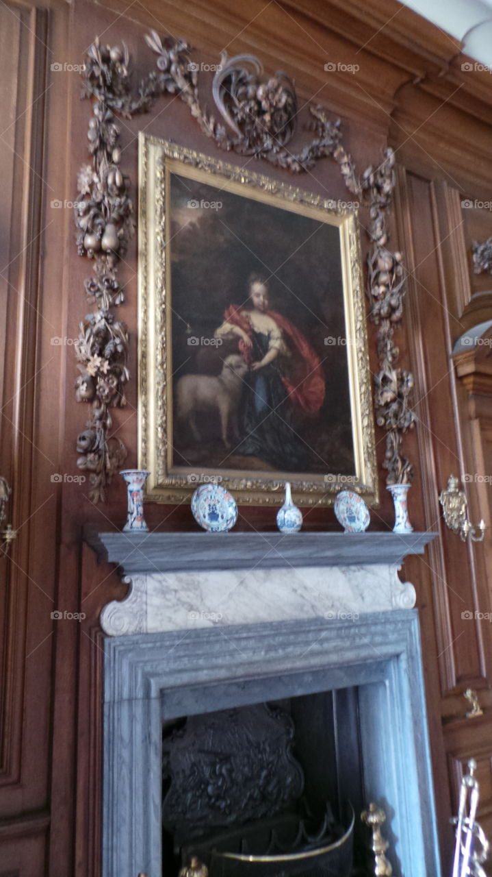 boy with sheep. fine arts hanging in belton stately home. England.  16th century house