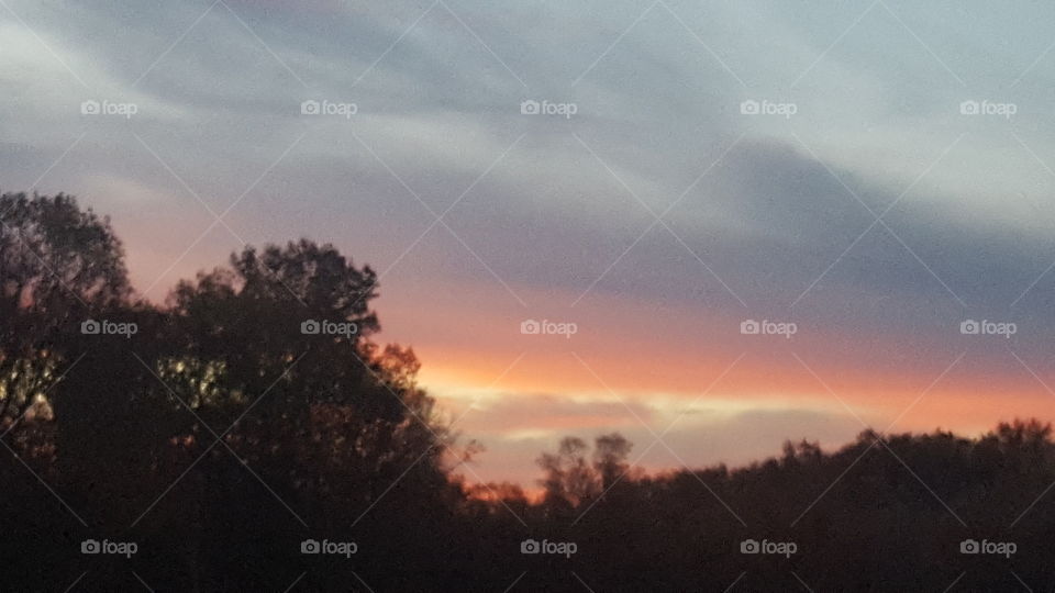 colorful sunrise above the treeline