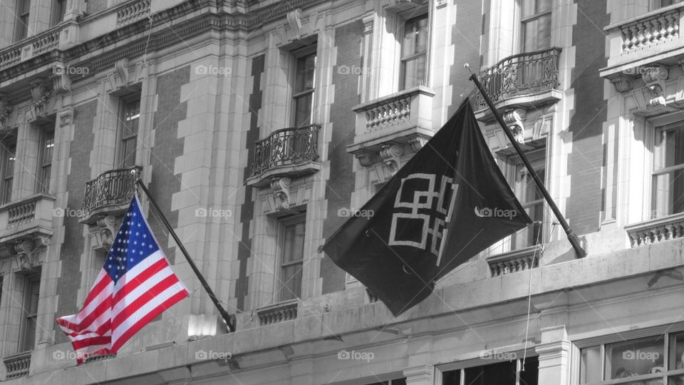 Red White and Blue American Flag on a City Building with a Black and White Background