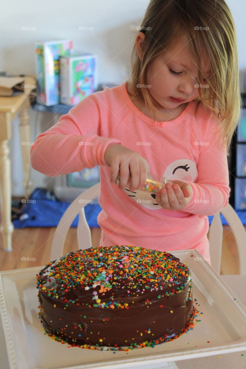 decorating a birthday cake