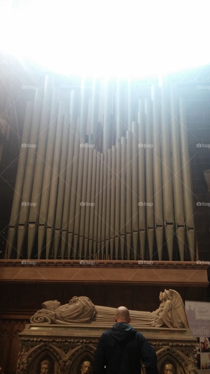Illumination on the shiny pipes of a local church organ on a beautiful spring day