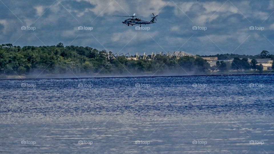 Naval helicopter practicing diver in the water drills