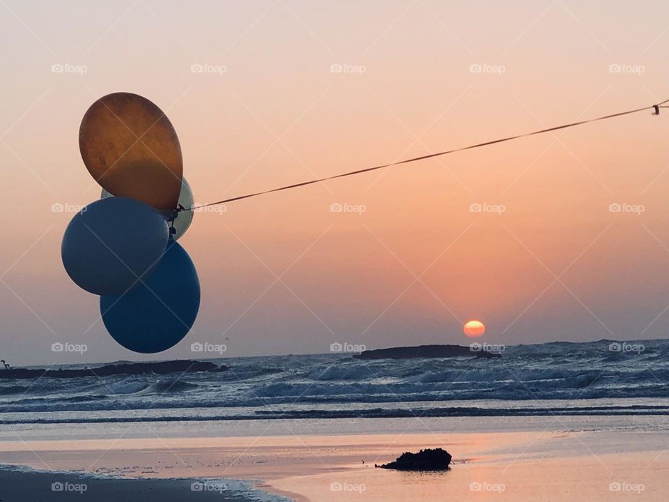 Multicolour balloons against splendid sunset at essaouira city in morocco.