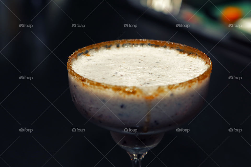 Smoothie look as alcoholic drink, magherita cocktail glass with milkshake banana fruit beverage, beautiful serving at quarantine 