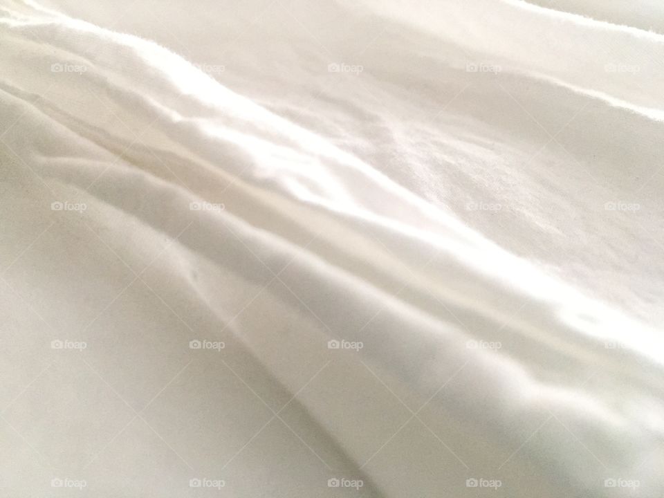 Close-up of organic white cotton sheets.