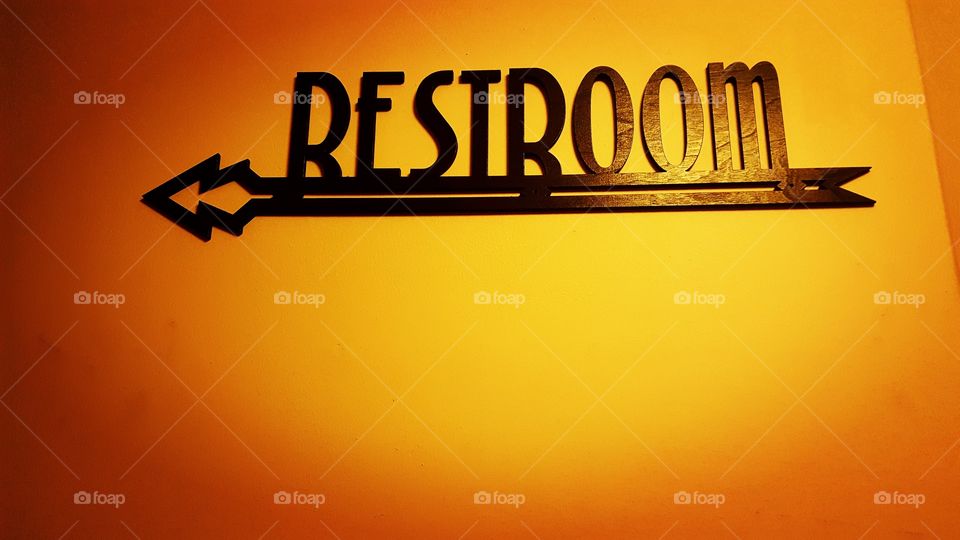Restroom sign points the way.