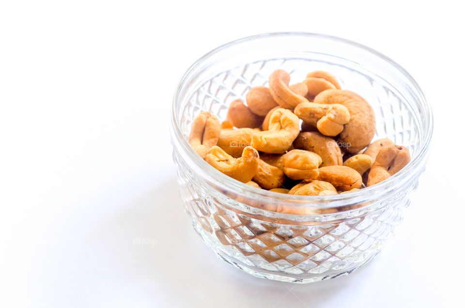 glass bowl with cashew nuts inside.