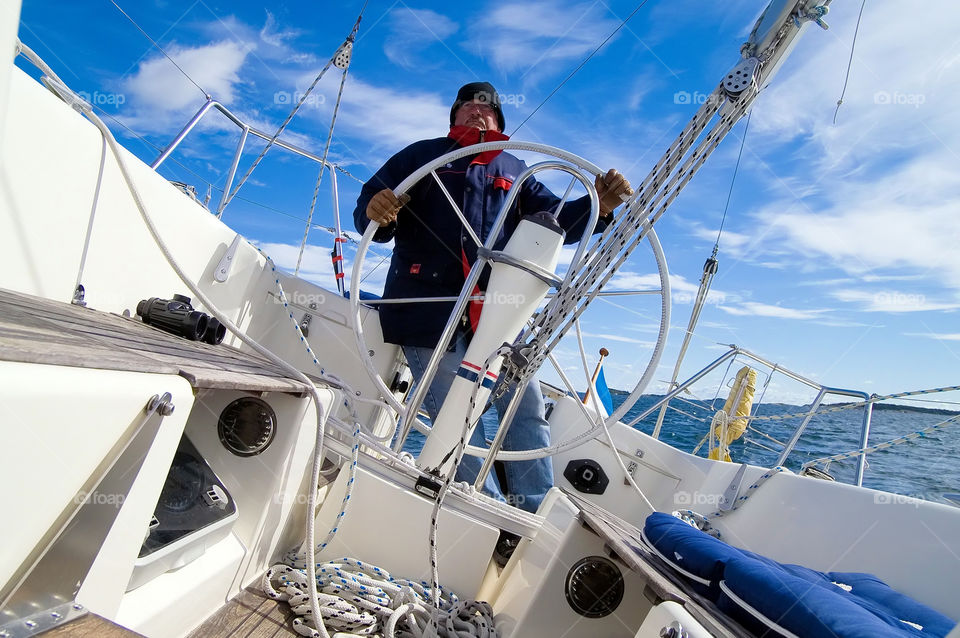 At the rudder. Out sailing with a friend, nice weather but cold.