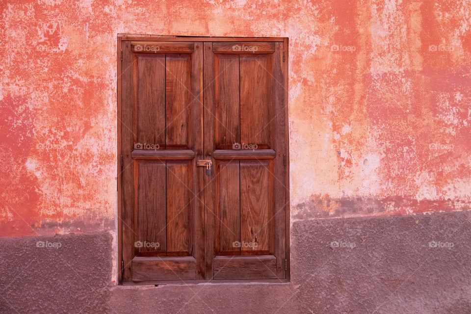 A locked brown wooden door in San Miguel de Allende, Mexico.