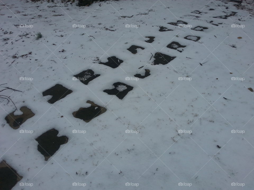Snow on the ground in the southern state of warm, Georgia, U.S.A. On the pavers in the yard.